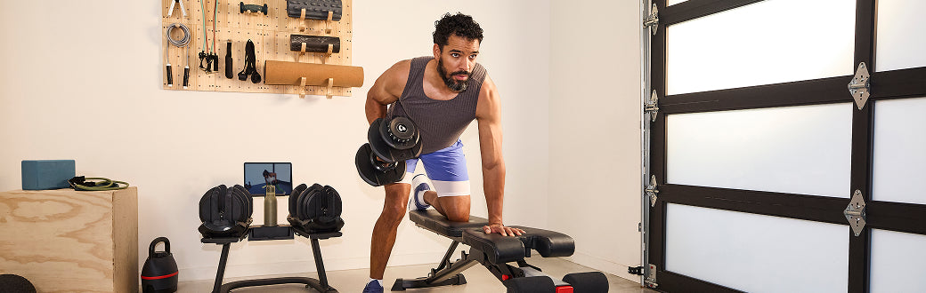 A man using the results series adjustable dumbbells.