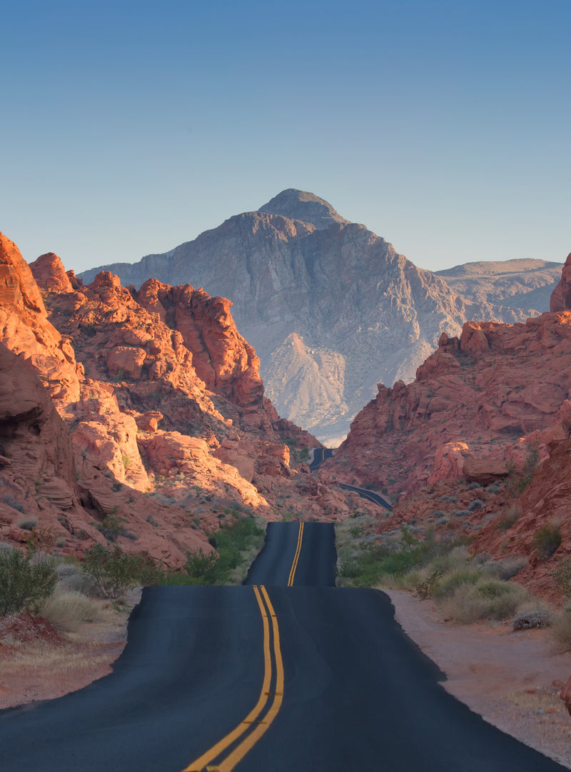 Road with mountains along its side and in the background.