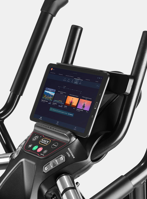Tablet displaying JRNY app screen placed on the BowFlex Max Trainer M6 media shelf.