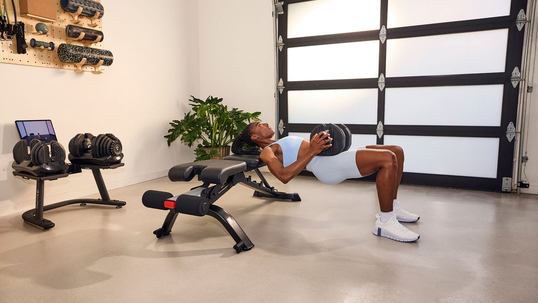 Woman exercising with a single Results Series 1090 dumbbell