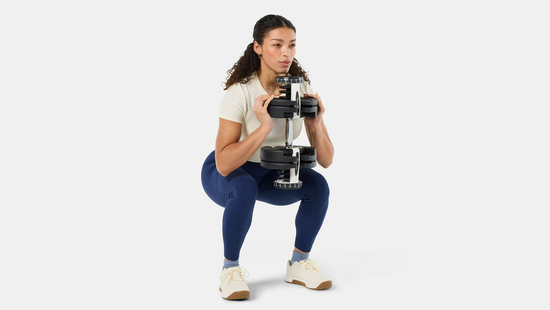 BowFlex Results Series 90 SelectTech Dumbbells - woman doing a squat with dumbbell